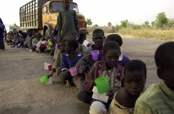 Child soldiers from Sudan People's Liberation Army wait for food during the demobilization of soldiers at Rumbek, southern Sudan, in 2001. The government of Southern Sudan said Monday it will make its former rebel army children free by the end of the year, a policy change that will see at least 900 young troops purged from the military.